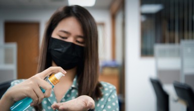 Asian woman wearing mask and alcohol antibacterial hand gel