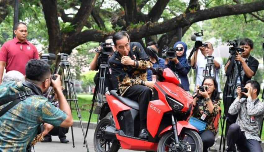 President Joko "Jokowi" Widodo poses on an electric motorcycle