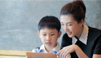 Asian mother son using tablet computer