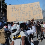 to protest officer deaths, haiti police block roadways and breach into airports