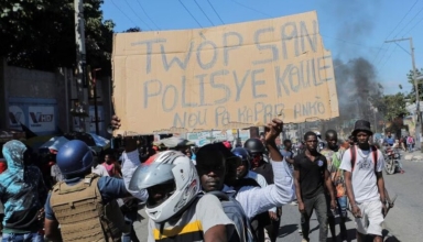 to protest officer deaths, haiti police block roadways and breach into airports