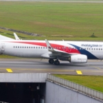 malaysian airlines passenger arrested in sydney after mid air incident