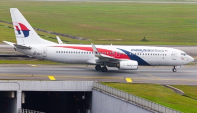 malaysian airlines passenger arrested in sydney after mid air incident